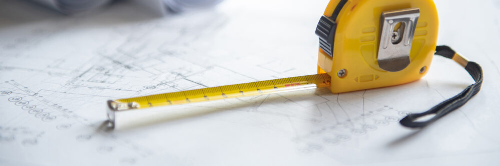 Tape measure and architectural drawing on working table